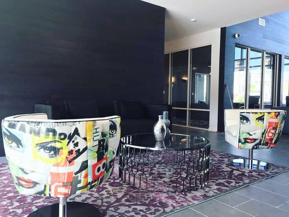 a living room with a black wall and a table and chairs