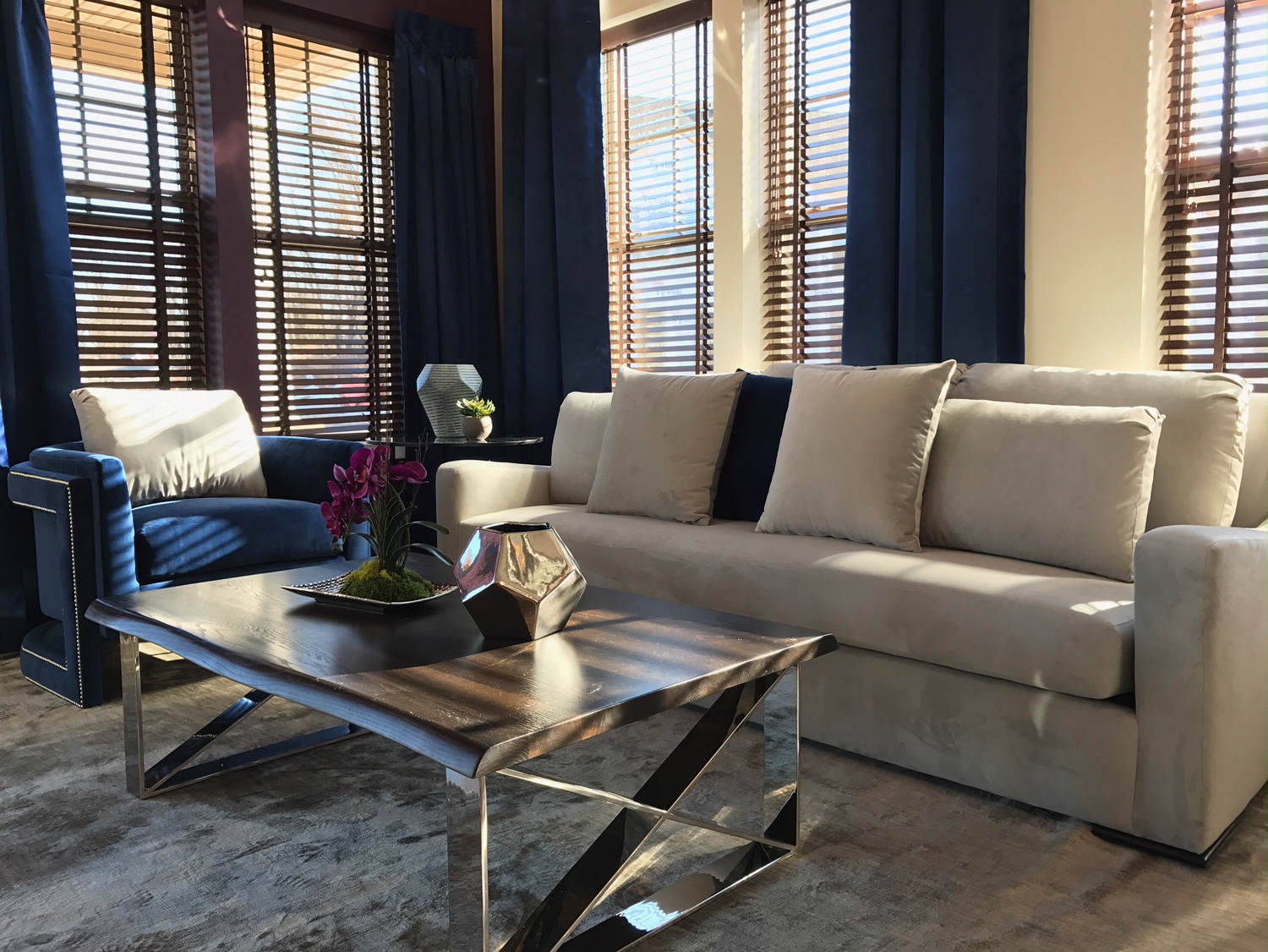 a living room with white couches and a coffee table