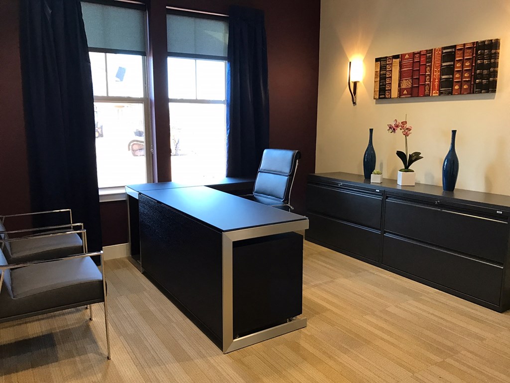 a desk and chairs in a room with a window