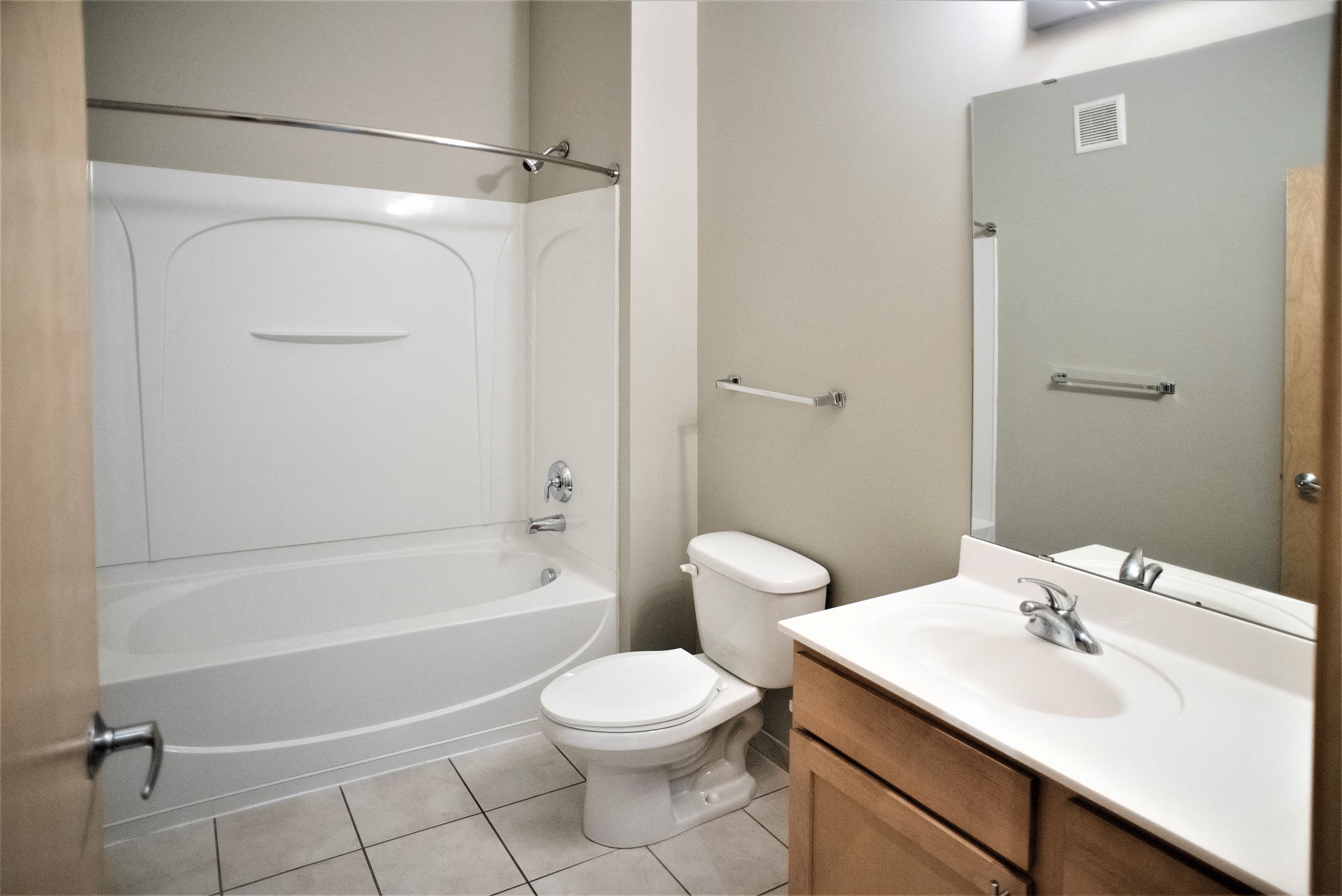 a bathroom with a shower toilet and sink and a mirror