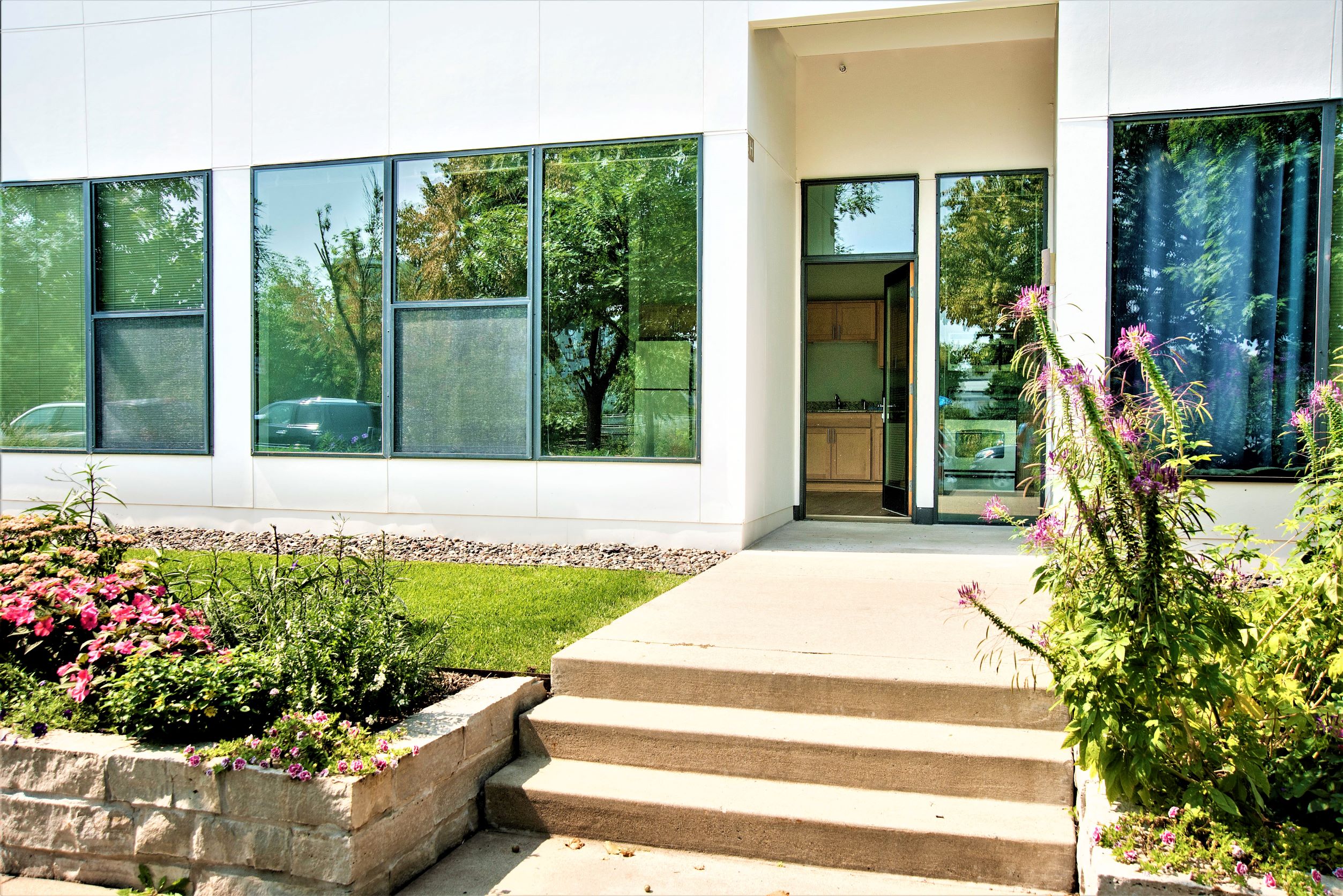 the front of a house with steps and a garden