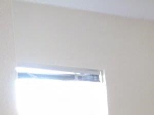 an empty room with wood floors and an air conditioner