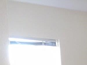 an empty room with wood floors and an air conditioner
