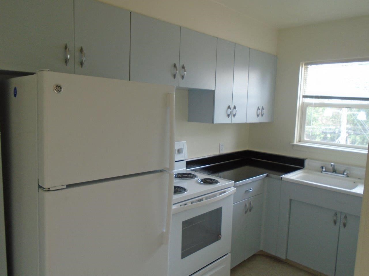 a kitchen with white appliances and white cabinets