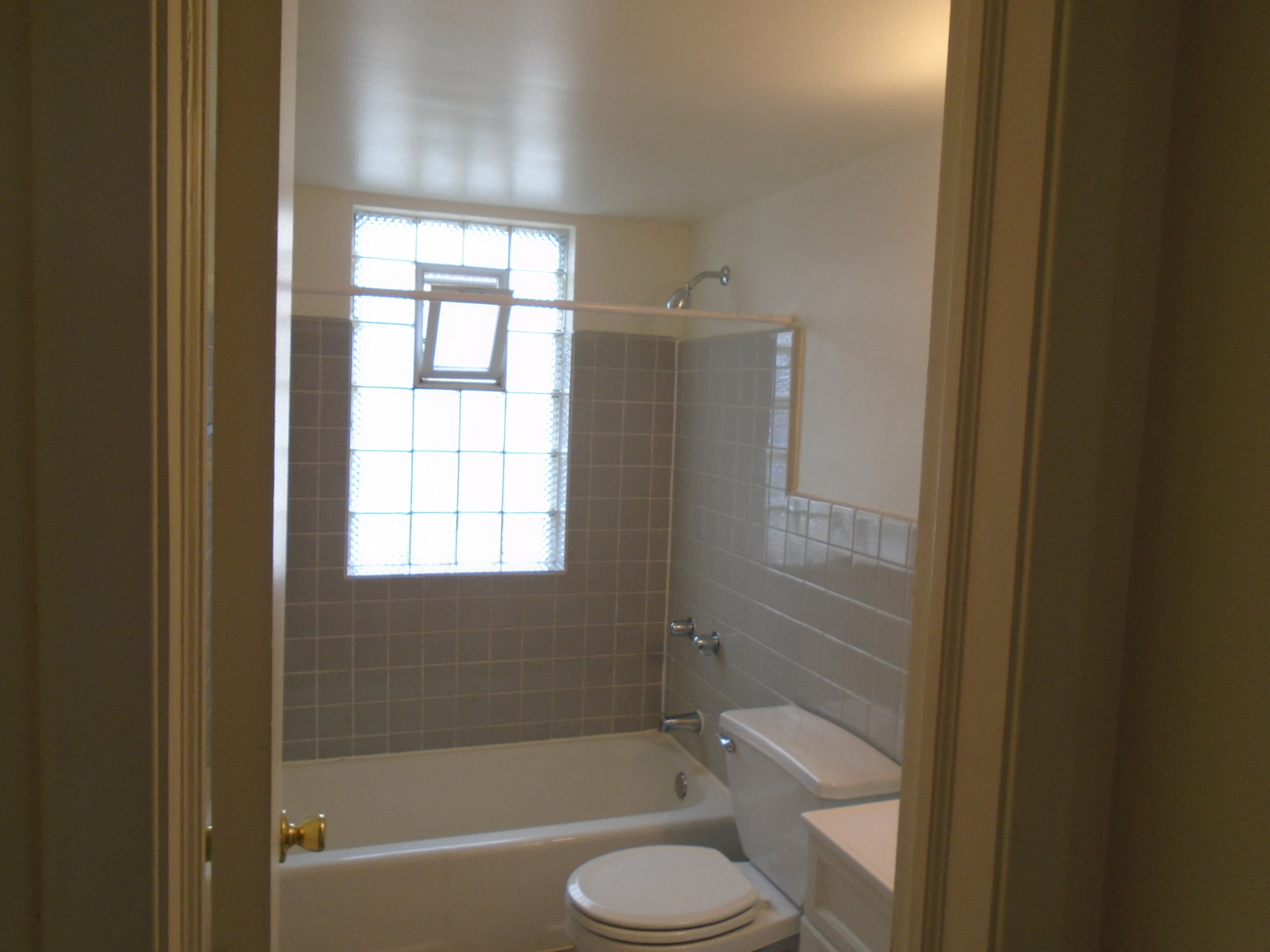 a small bathroom with a toilet and a bath tub