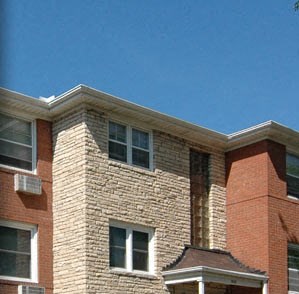 a brick building with a lawn in front of it