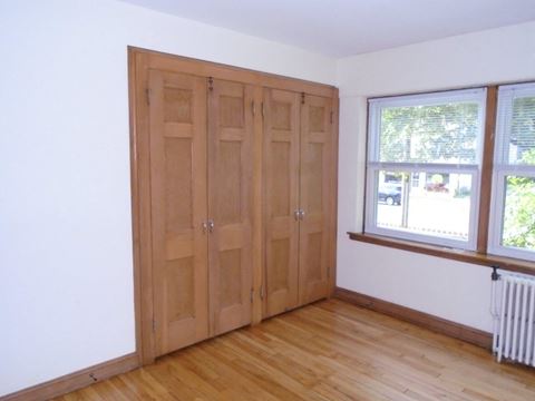 an empty room with wooden floors and wooden doors