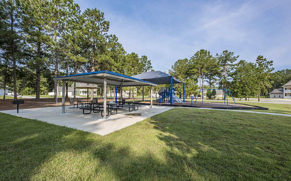 a park with picnic tables and a playground