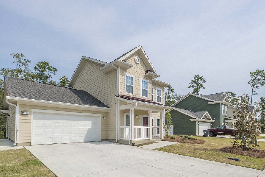 a beige house with a white garage door