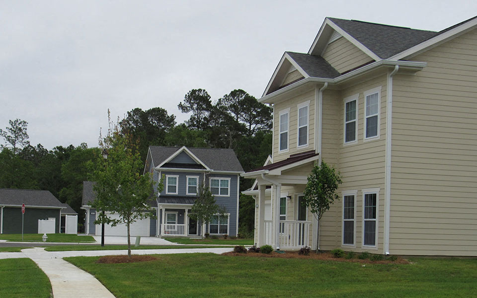 a row of homes on the side of a street