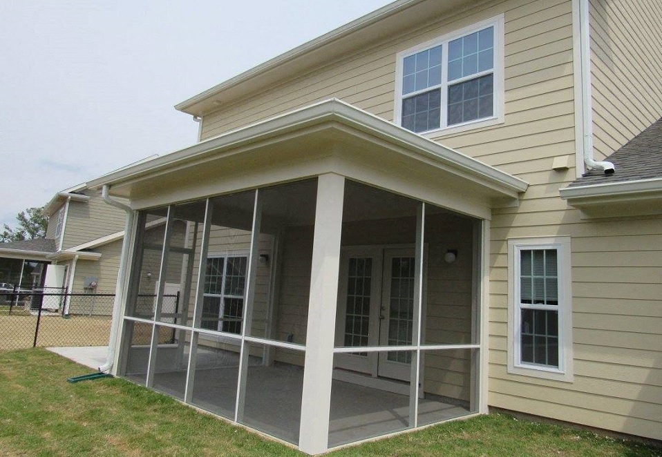 a screened in porch in front of a house