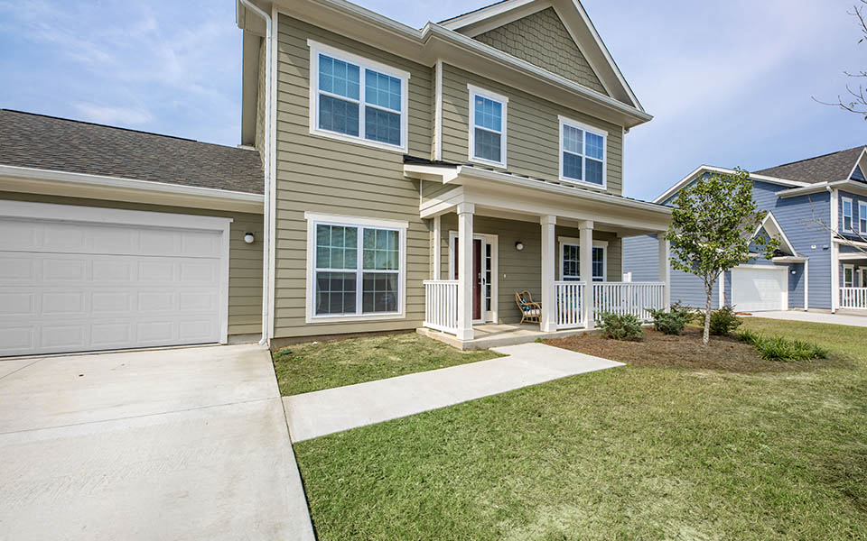 a tan house with a white garage door