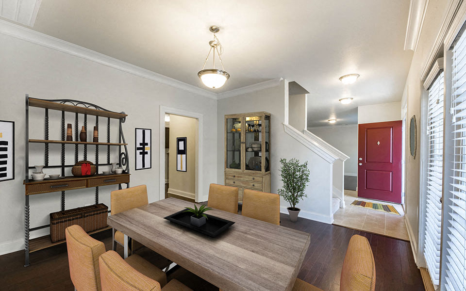 a dining room with a wooden table and chairs