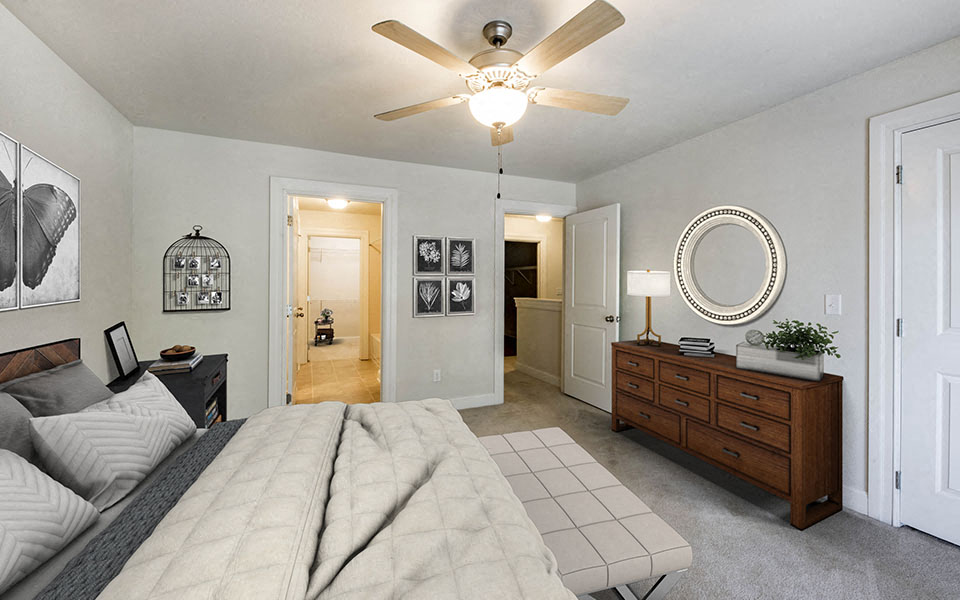 a bedroom with a bed and a ceiling fan