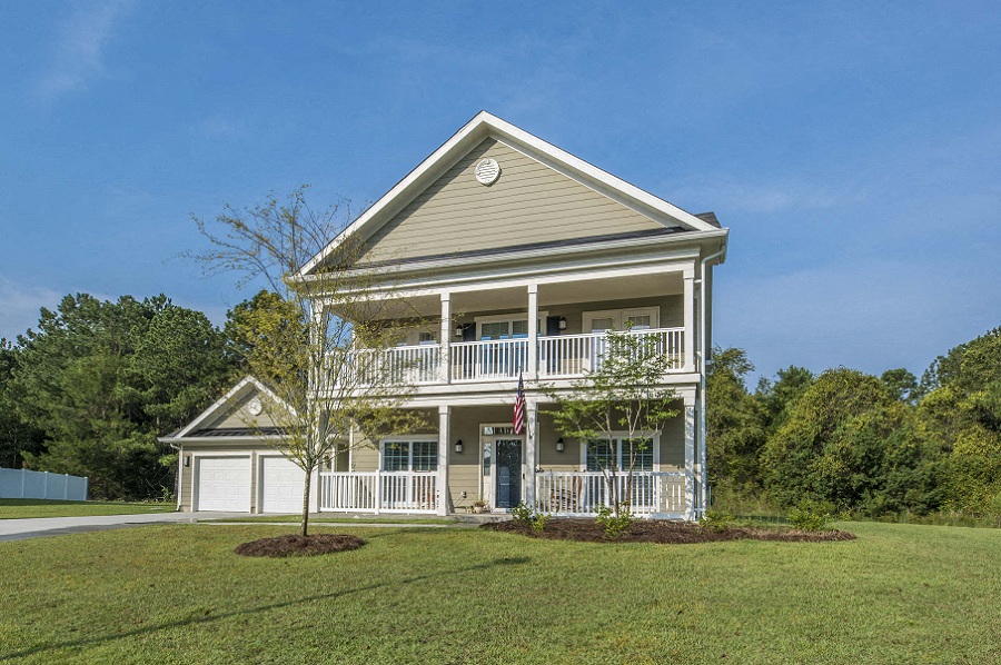 a house with a lawn and a flag in front of it