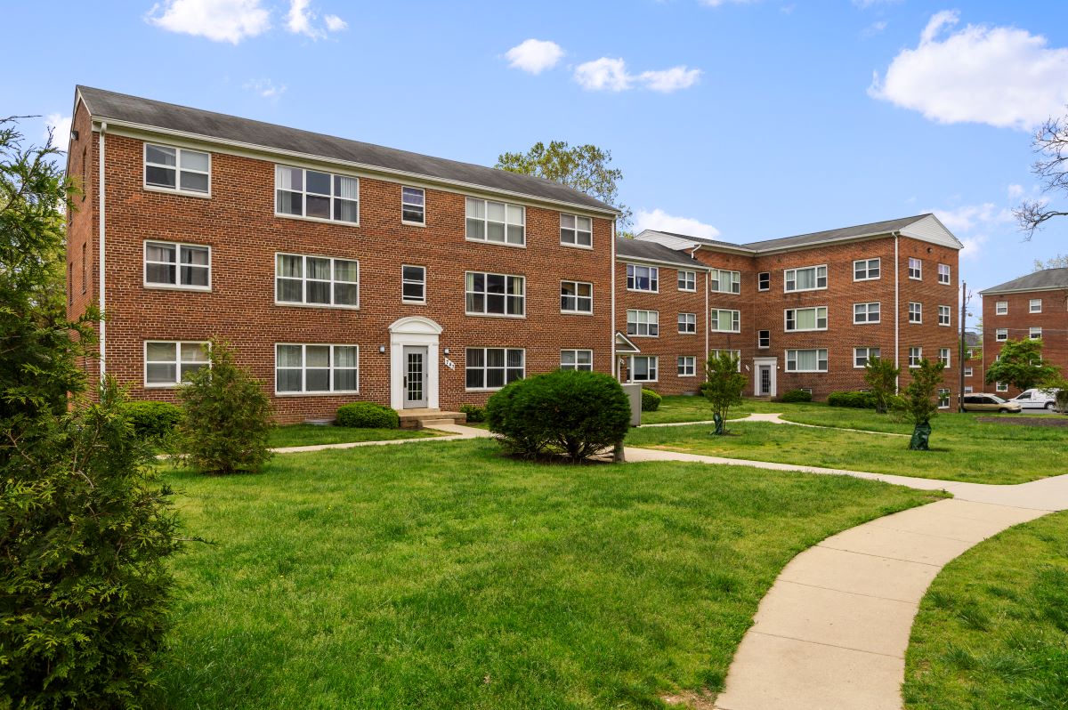a brick building with a sidewalk in front of it