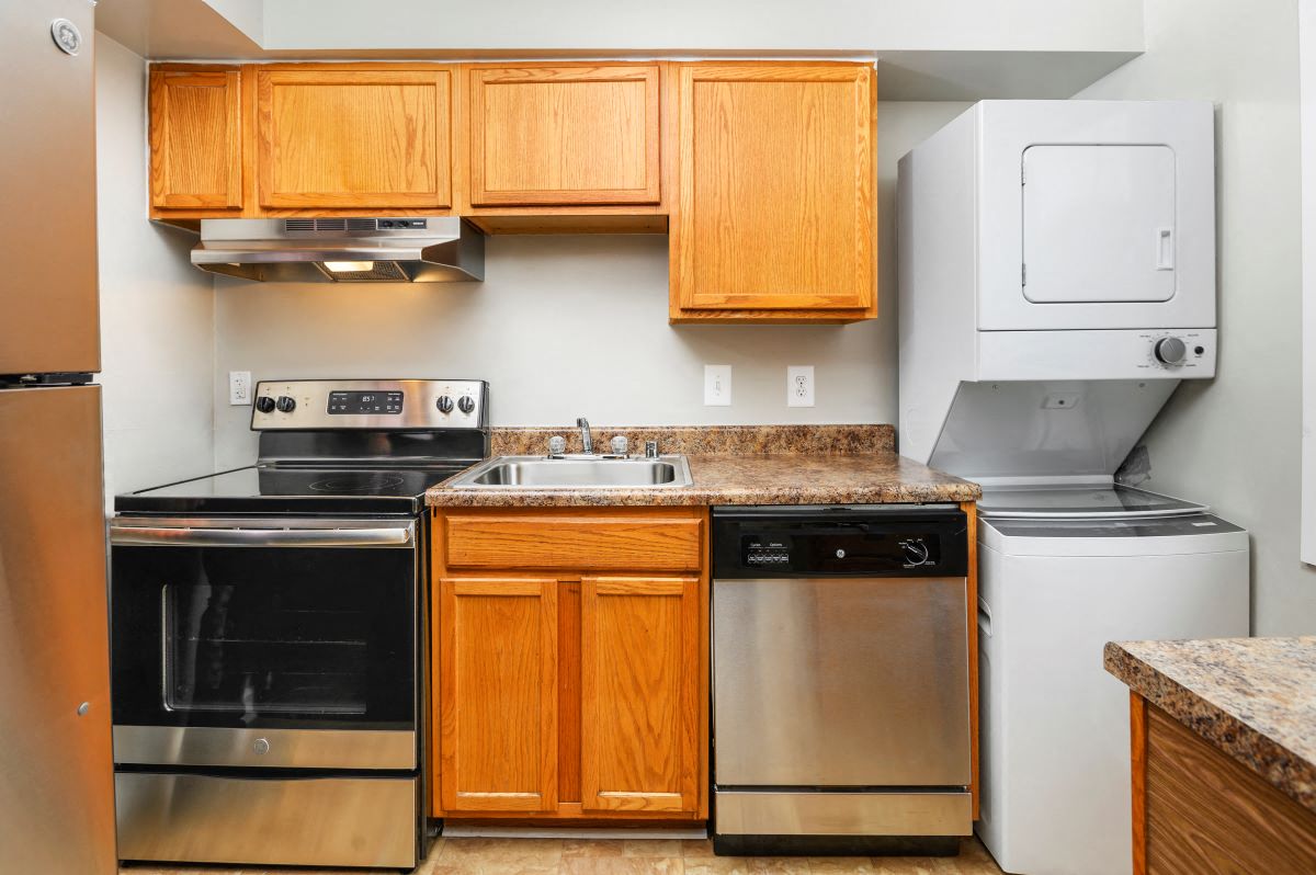 a kitchen with stainless steel appliances and wooden cabinets