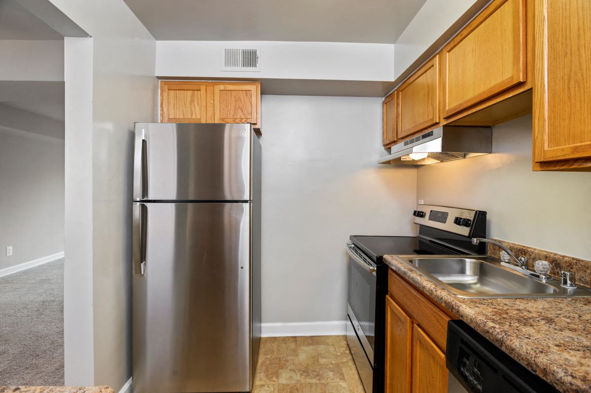 a kitchen with stainless steel appliances and wooden cabinets