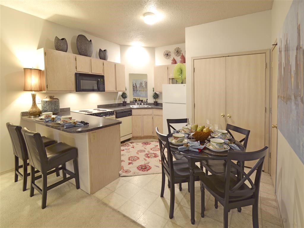 a kitchen and dining room with a table and chairs