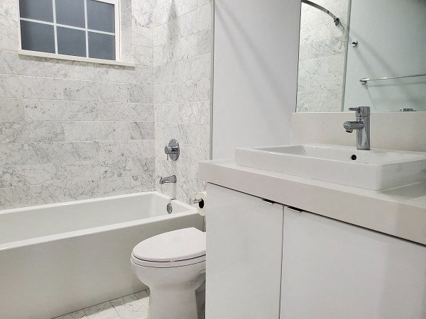 a bathroom with a sink toilet and a bath tub