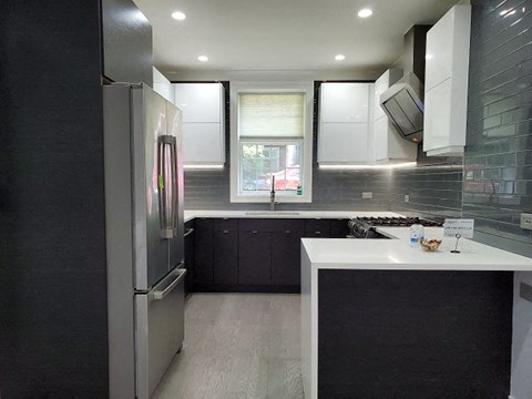 a kitchen with a refrigerator and a sink