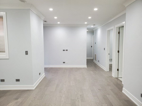 an empty room with white walls and a wooden floor