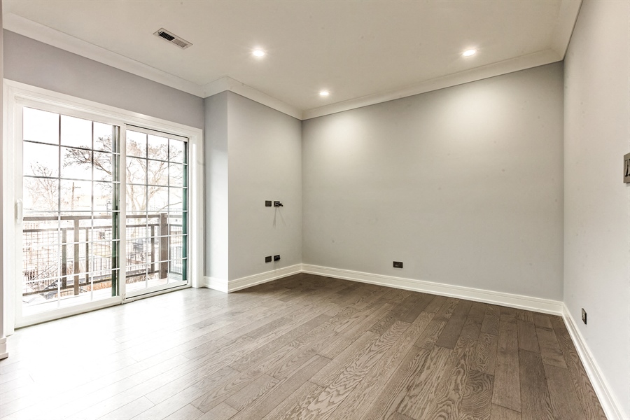 the living room of a new home with white walls and wood floors