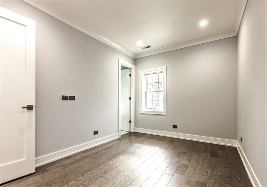 the living room of a new home with white walls and wood floors
