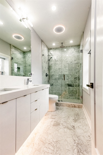 a bathroom with a shower and a sink and a toilet