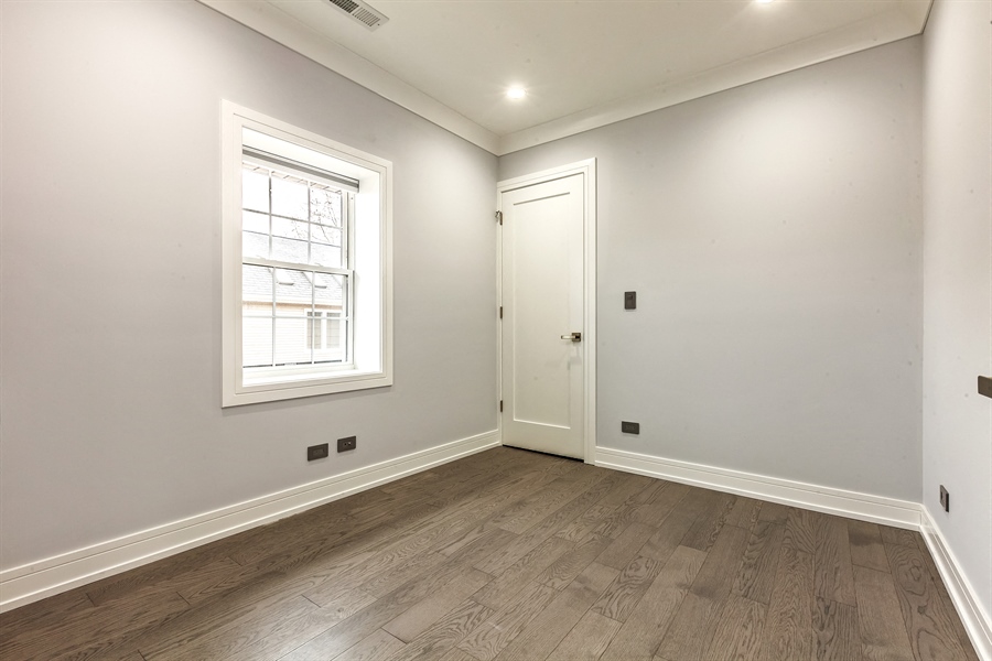 an empty room with white walls and a window