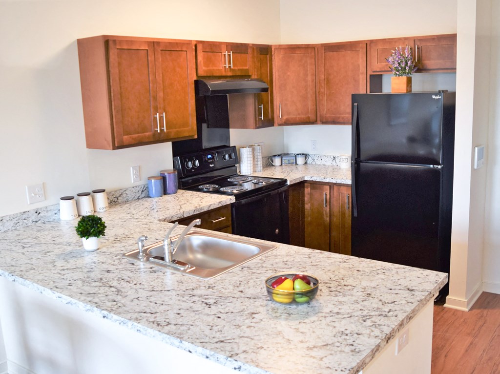 a kitchen with black appliances and granite counter tops