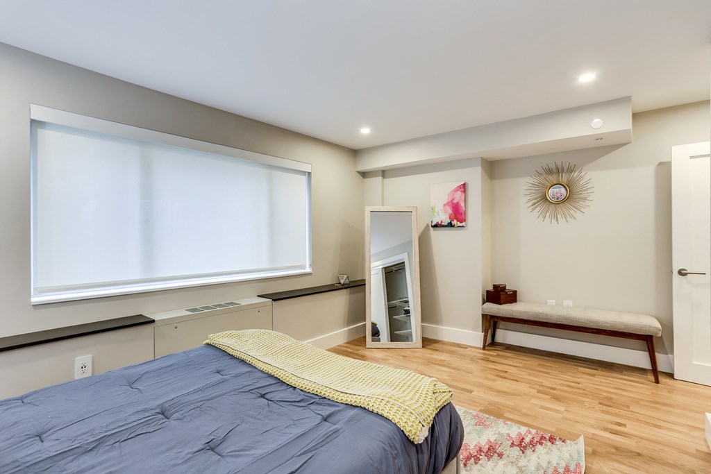 a bedroom with a large bed and a fireplace