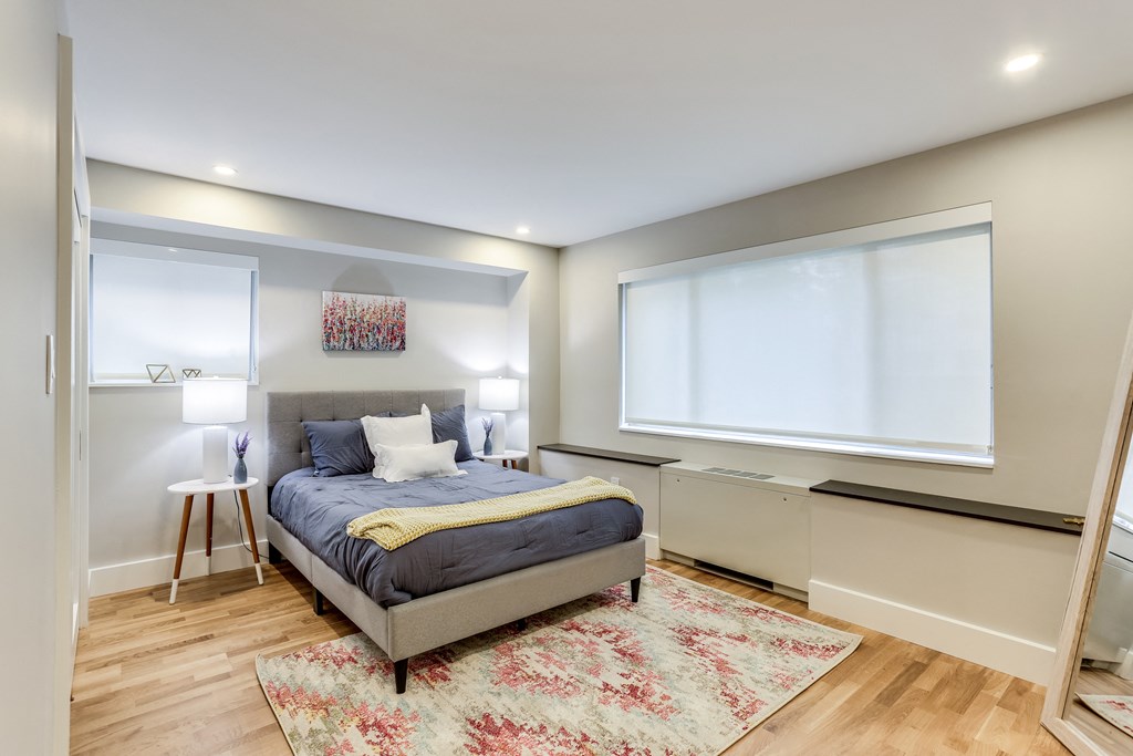 a bedroom with a bed and a large window