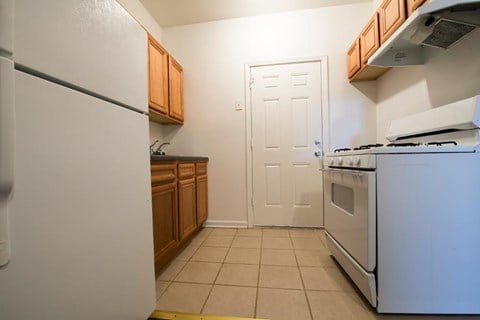 a kitchen with a stove and refrigerator and a door