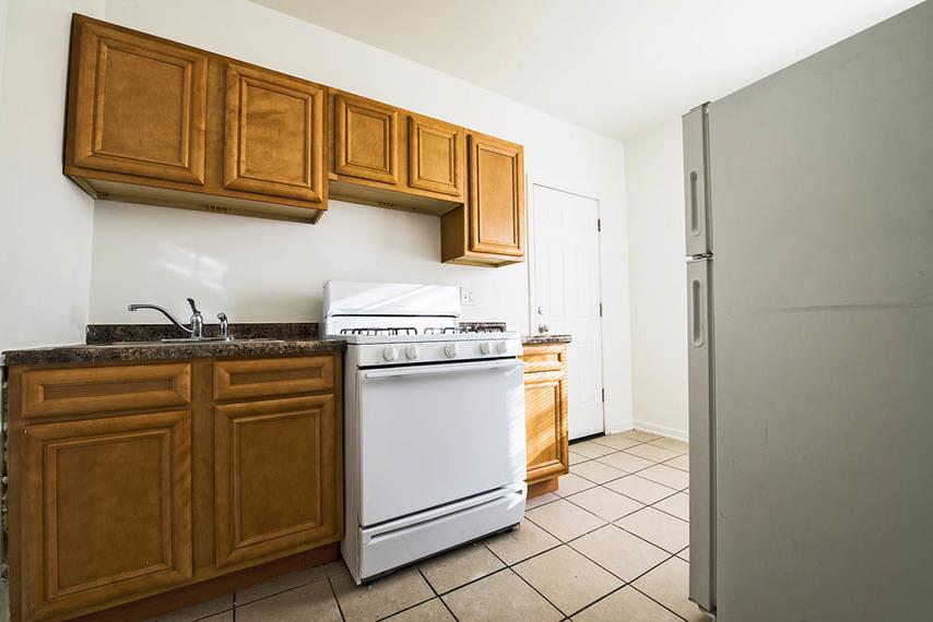a kitchen with a stove and a refrigerator