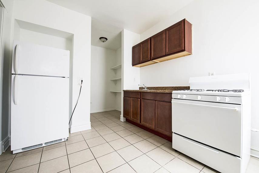 a kitchen with a stove and a refrigerator