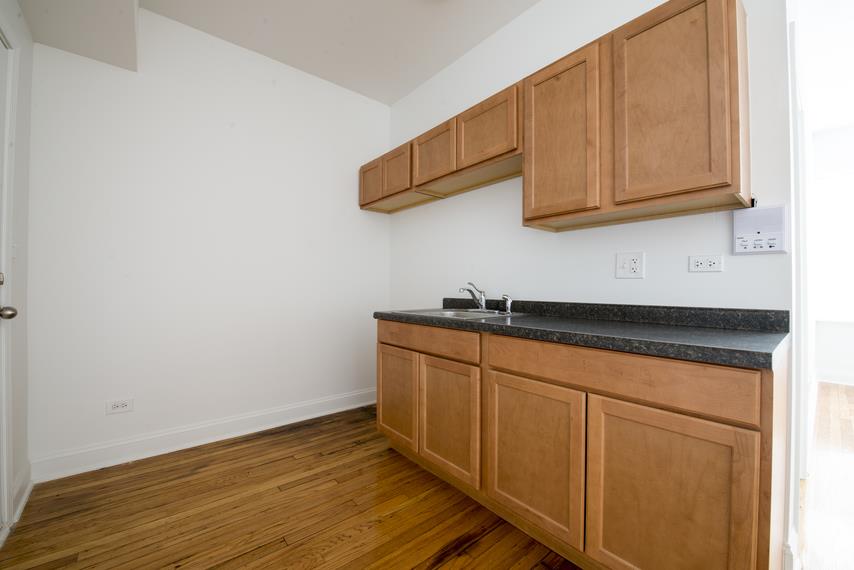 a kitchen with wooden cabinets and a sink