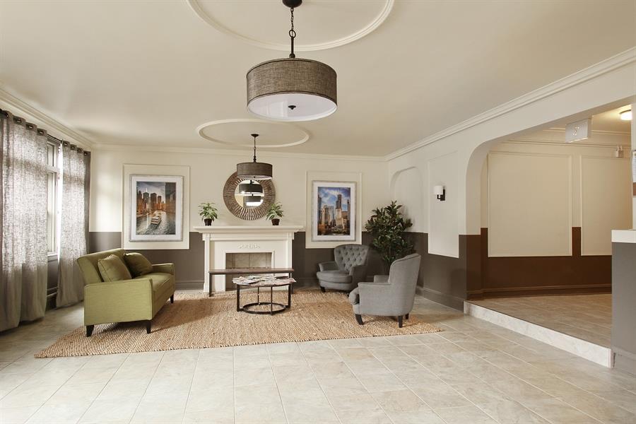 a living room with couches and chairs and a fireplace