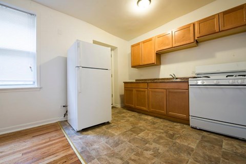 a kitchen with a refrigerator and a stove