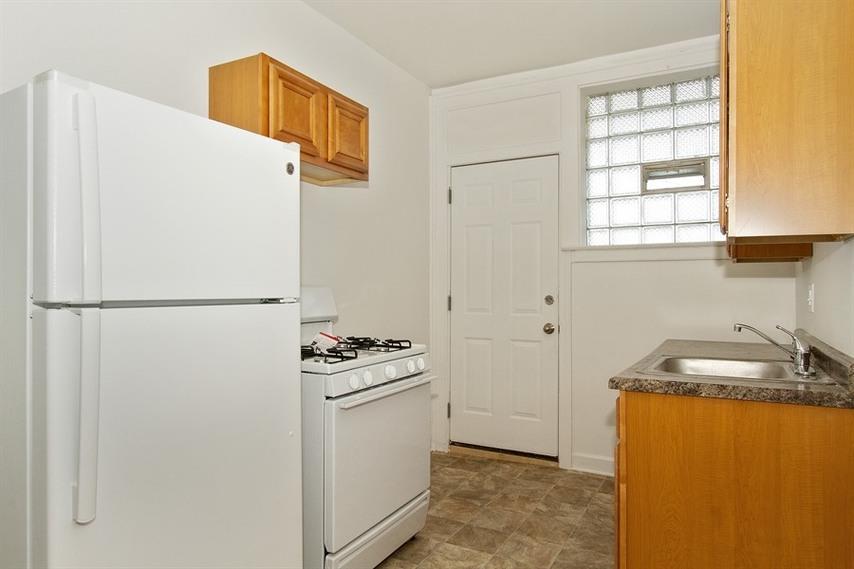 a kitchen with a stove refrigerator and sink