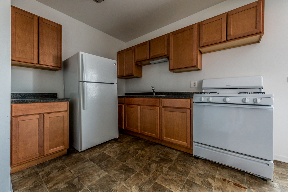 a kitchen with white appliances and wooden cabinets