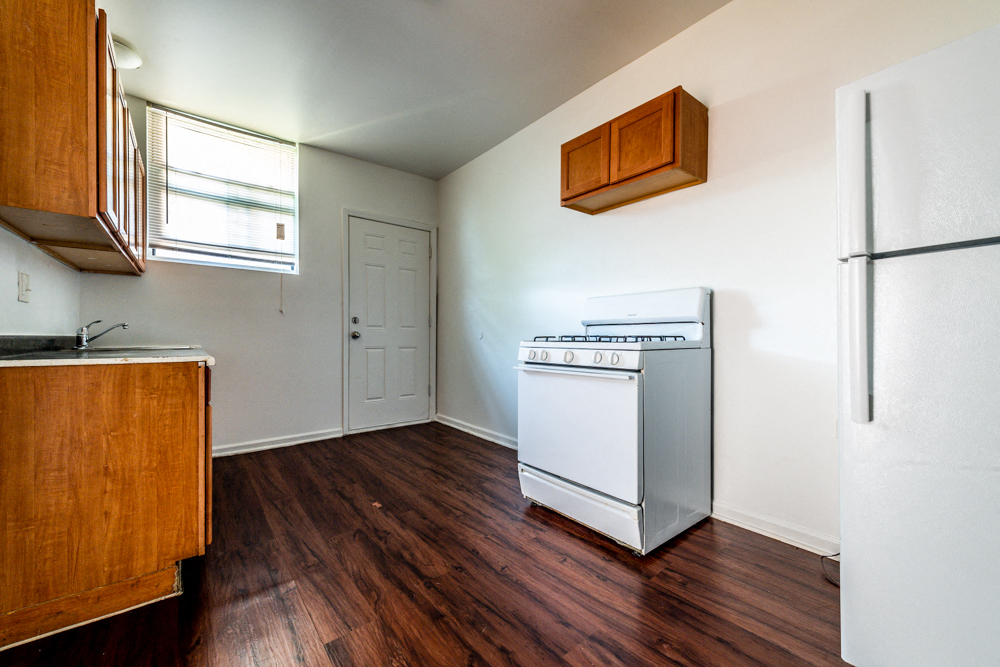a kitchen with a stove and a refrigerator