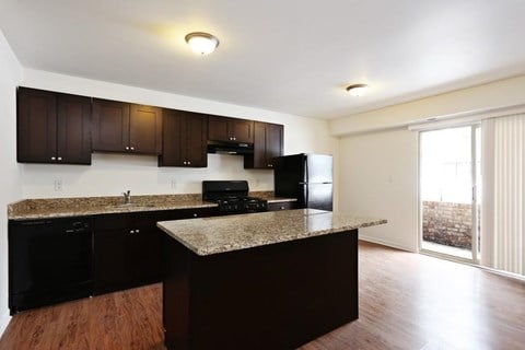a kitchen with a granite counter top and a refrigerator