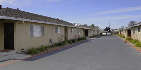 an empty street with rows of houses on the side of it