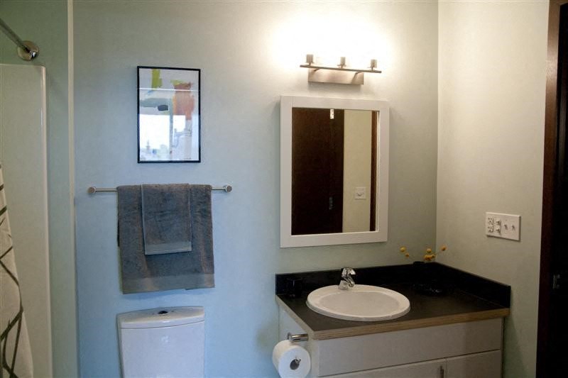 a bathroom with a sink and a mirror and a toilet