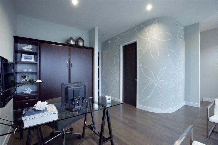 a living room with a desk and a television