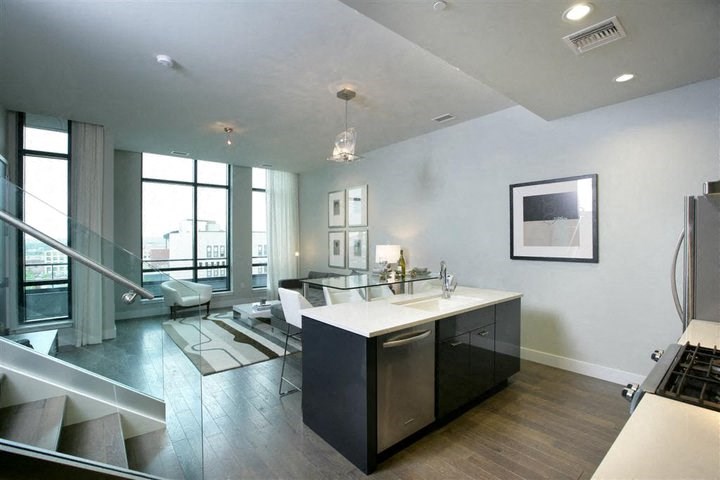 a kitchen and a living room with a table