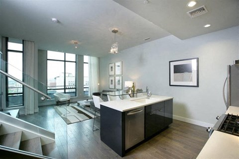 a kitchen and a living room with a table