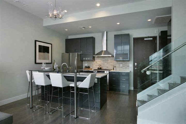a kitchen with a bar and a table with chairs