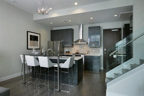 a kitchen with a bar and a table with chairs